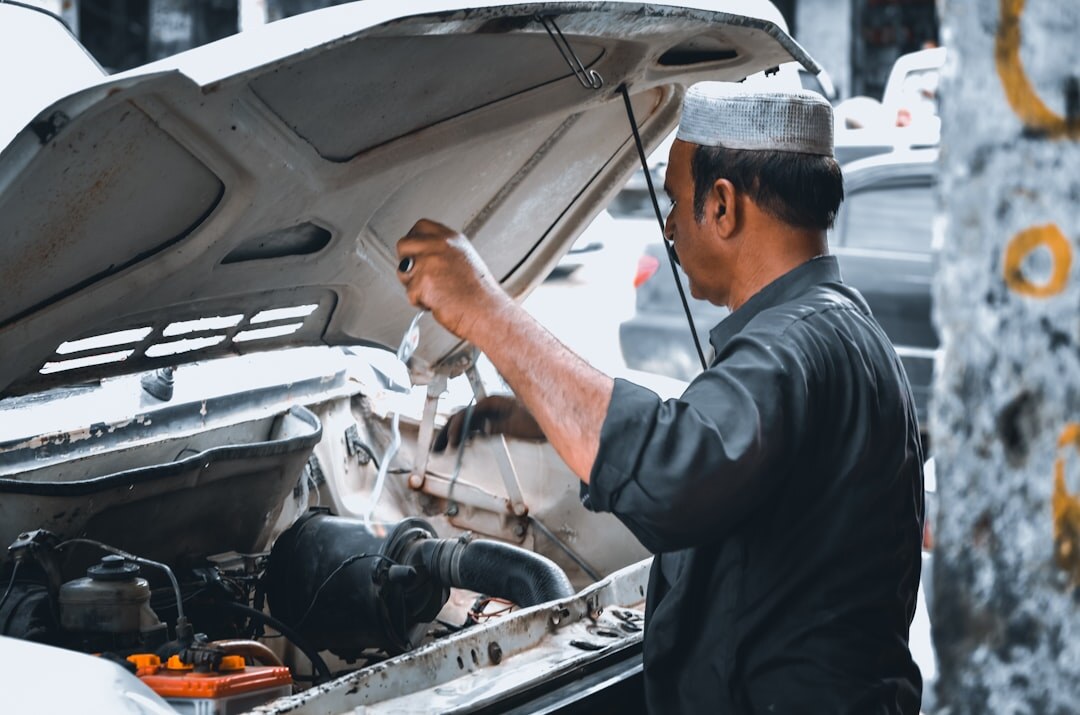 mechanic checking car engine