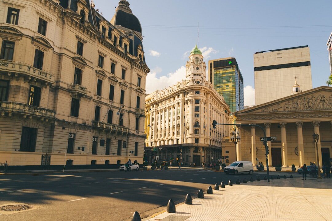 Sedan parked on a wide boulevard with classic architecture in Argentina