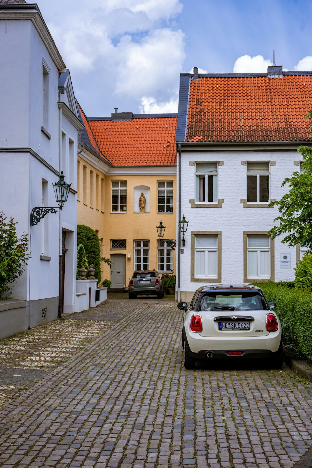 European premium hatchback parked on a cobblestone street in an old European city