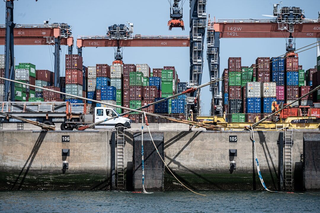 Rows of imported cars stacked at a shipping port terminal